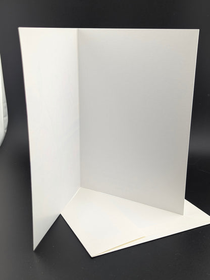 White greeting card with a plain design on a black background