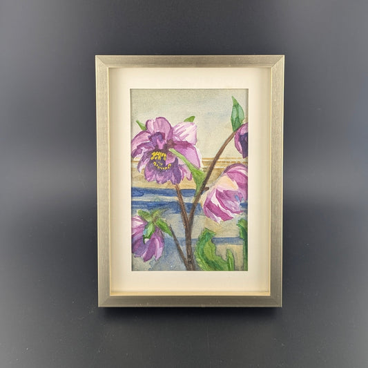 Framed artwork of purple flowers on a dark gray background