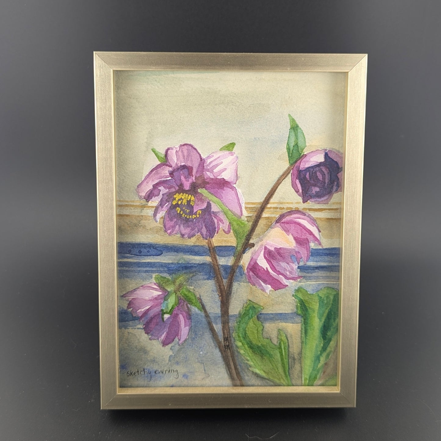 Framed artwork of purple flowers with a gray background
