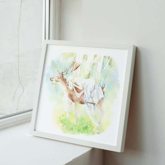 Framed watercolor painting of a deer on a wall next to a window.