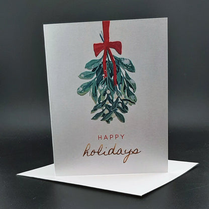 Greeting card with mistletoe design and 'Happy holidays' text on a dark background
