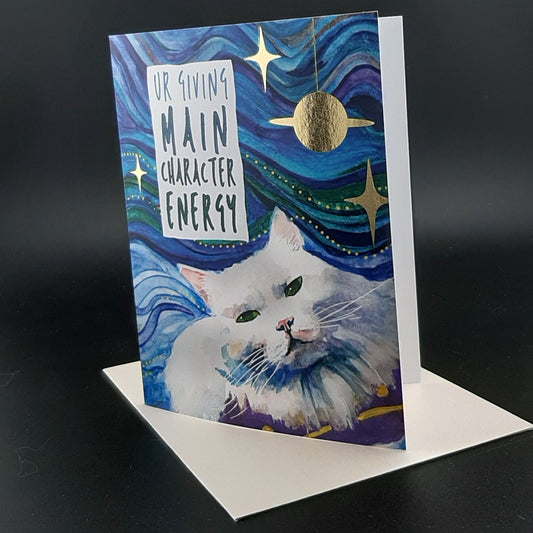 Foiled Greeting Card with a cat floating through space and the Gen Z text "Ur Giving Main Character Energy"